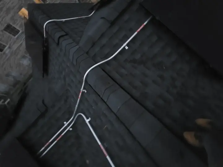 Conduit crossing roof shingles